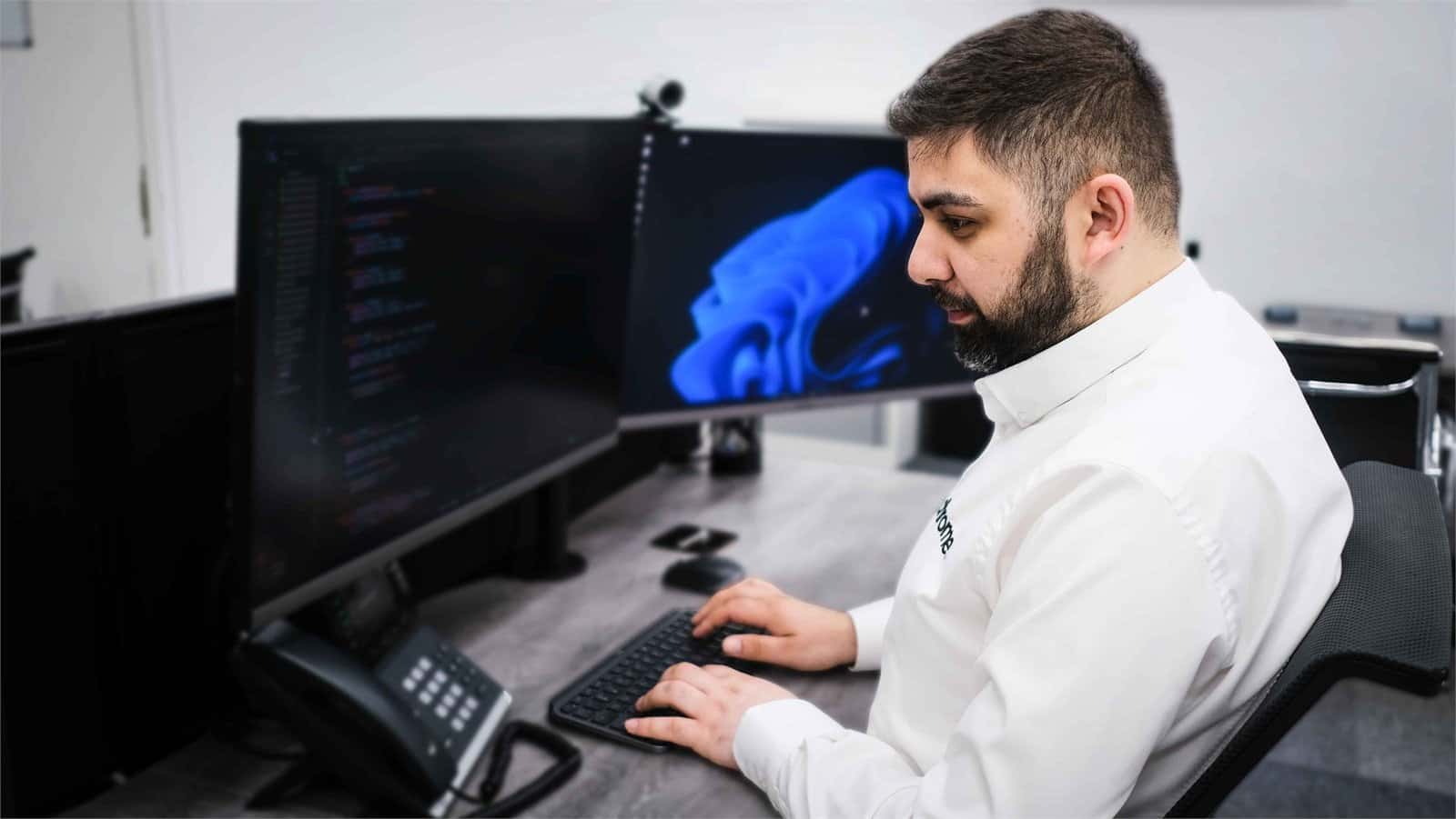 Ali working at his desk in the Chrome Telecom office, supporting satellite connectivity