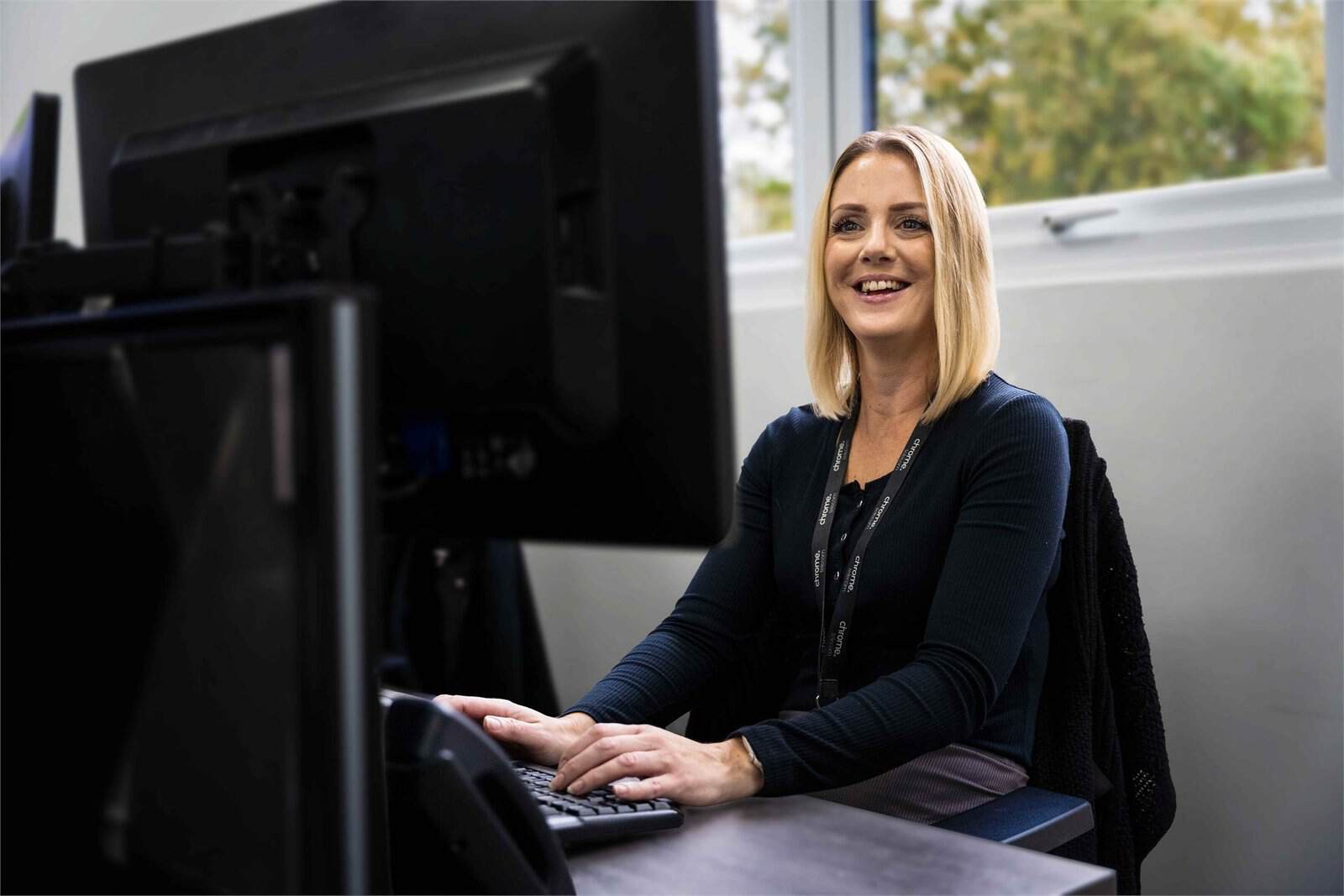 Gemma working at her computer, supporting cloud migration