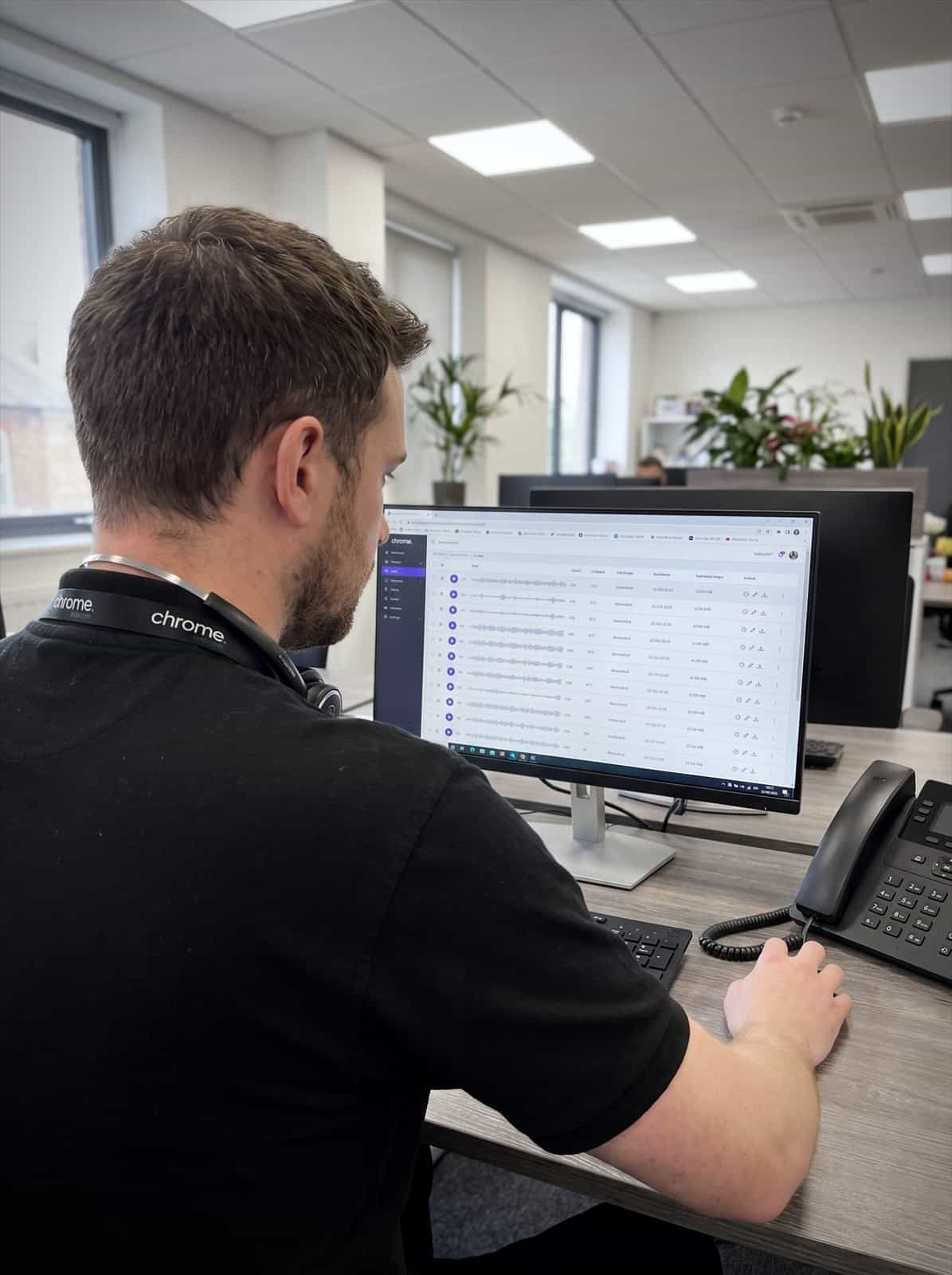A Chrome Telecom colleague reviews a list of recorded calls on screen, each with playback controls