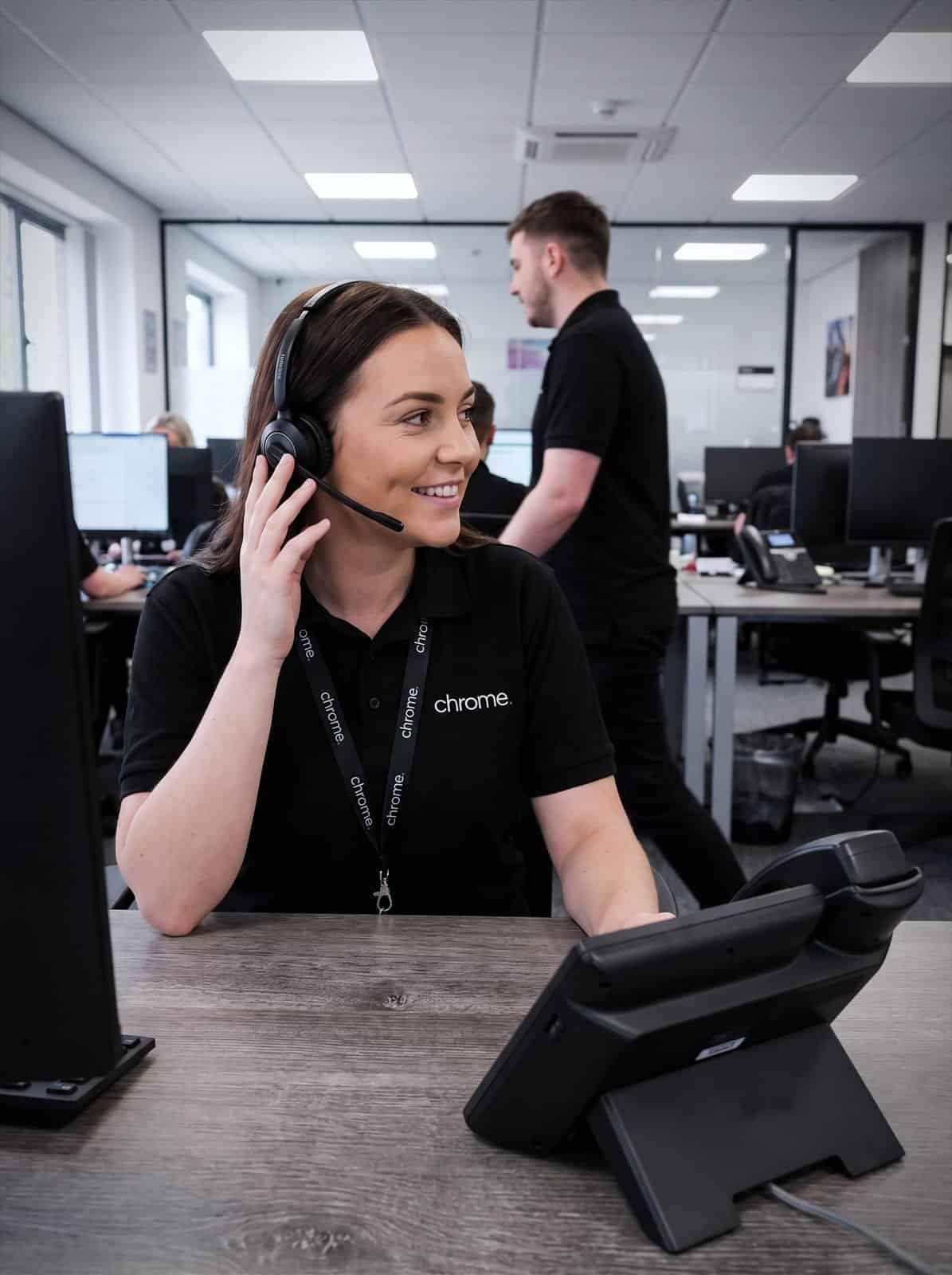 A Chrome Telecom advisor takes a call at her desk
