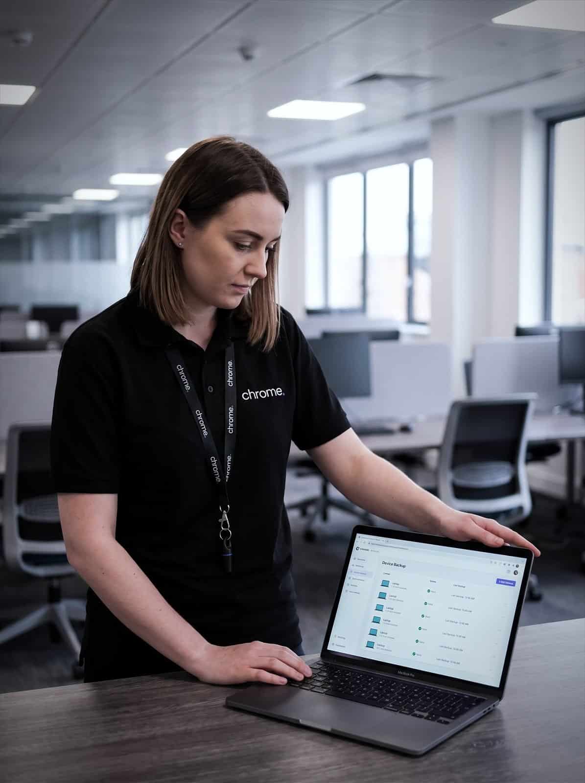 A Chrome Telecom colleague checks device backup status for a fleet of laptops