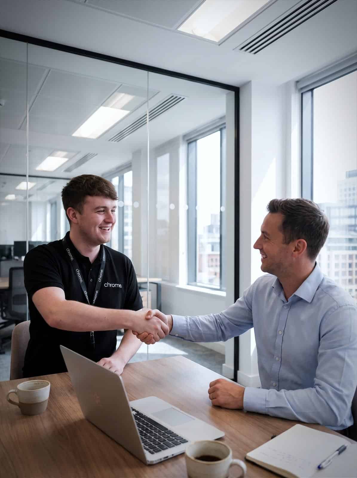 A Chrome Telecom colleague shakes hands with a business customer after a meeting