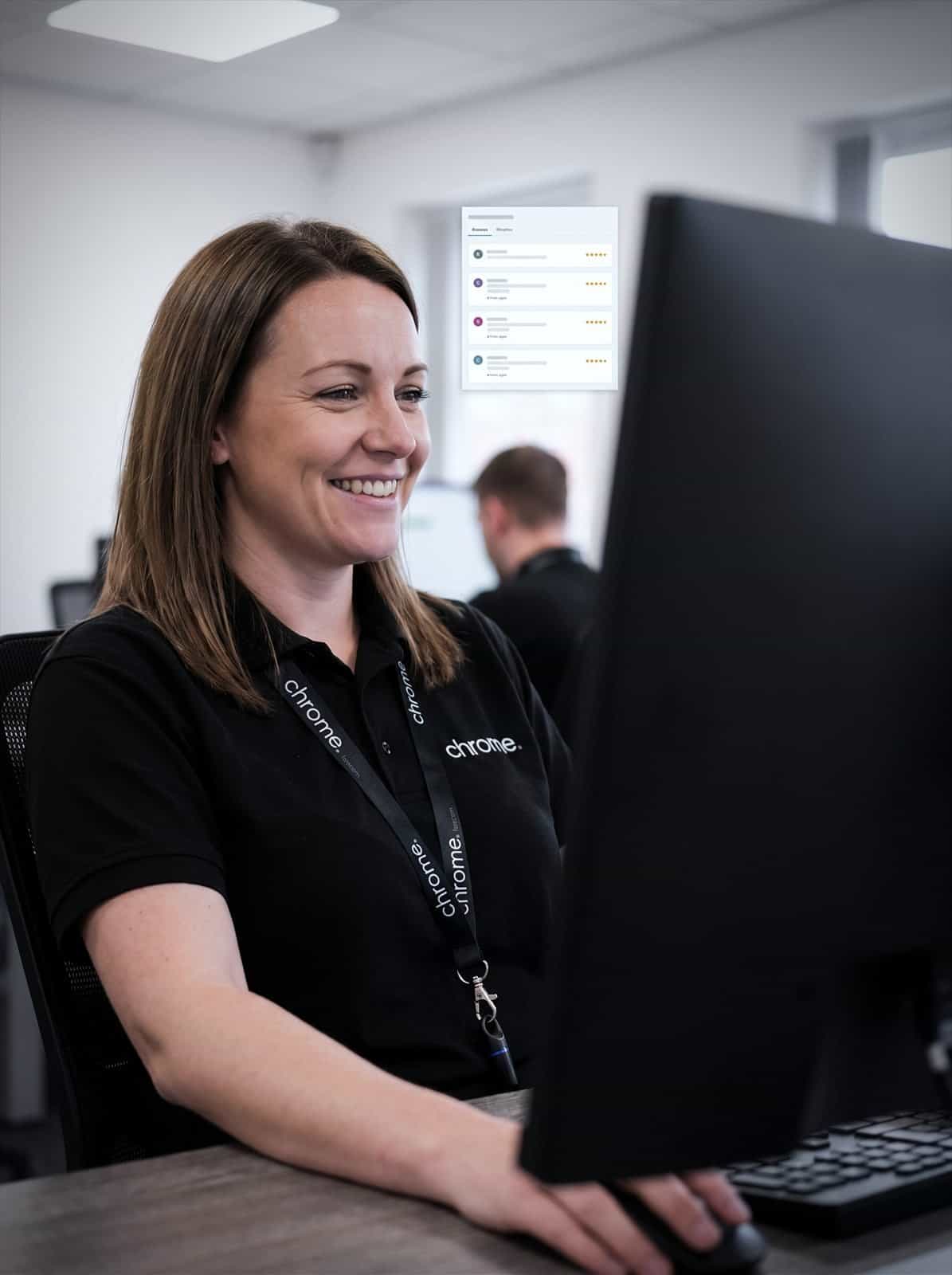A Chrome Telecom colleague reads customer reviews at her desk