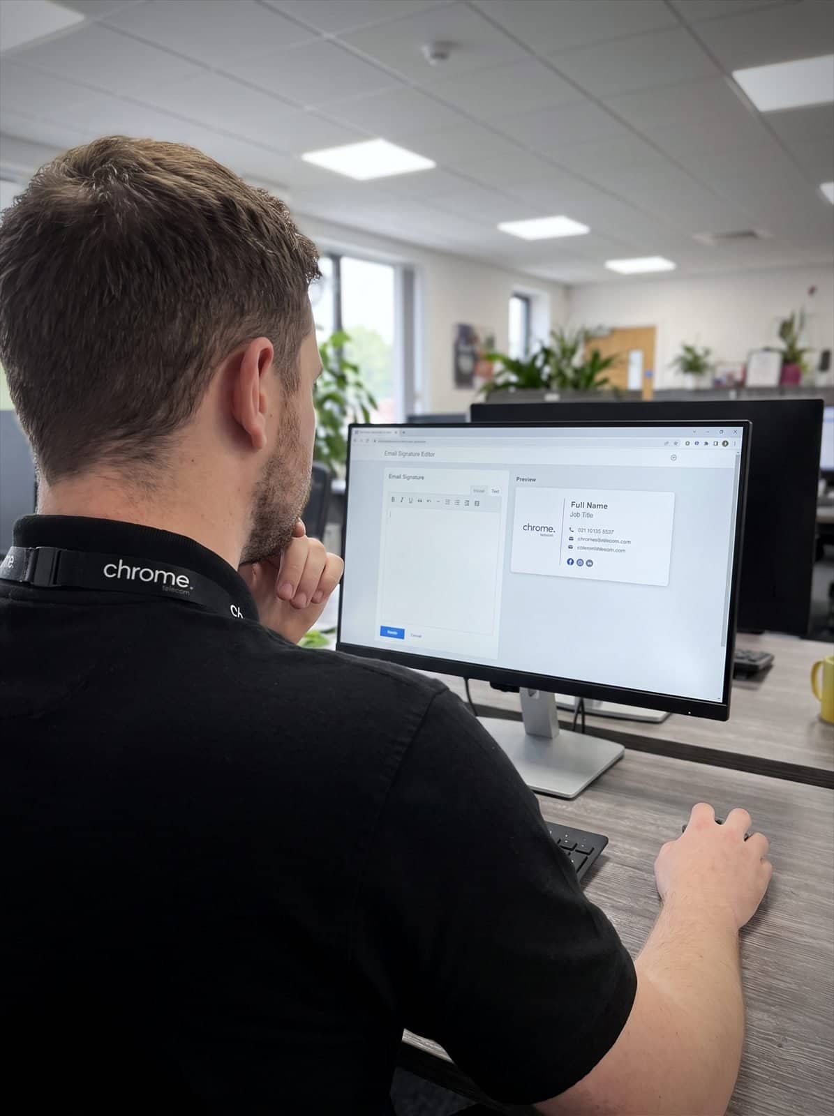 A Chrome Telecom colleague reviews an email signature template in a management tool on screen