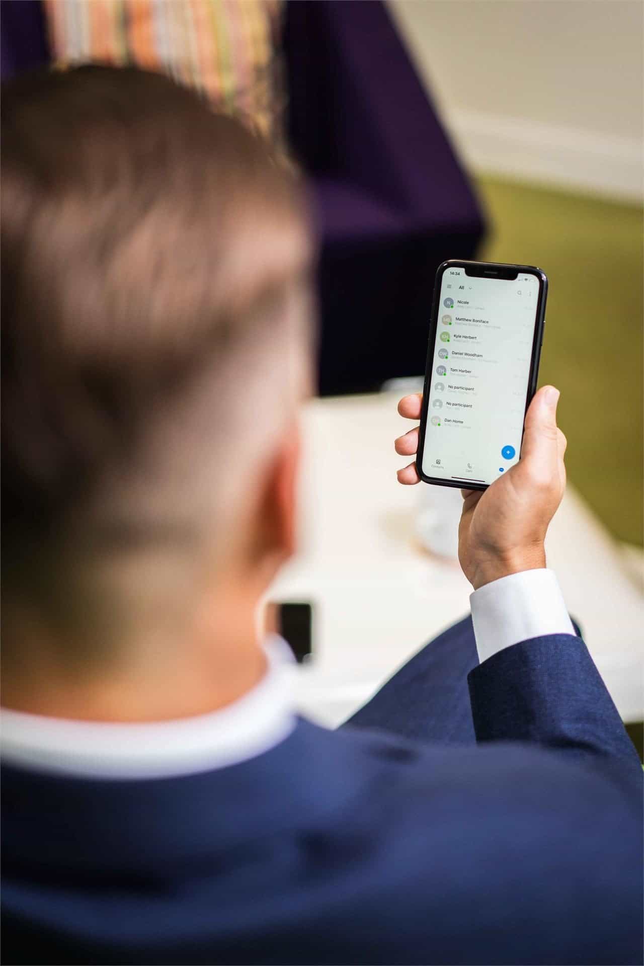 A Chrome Telecom team member using a business mobile phone, supporting network security