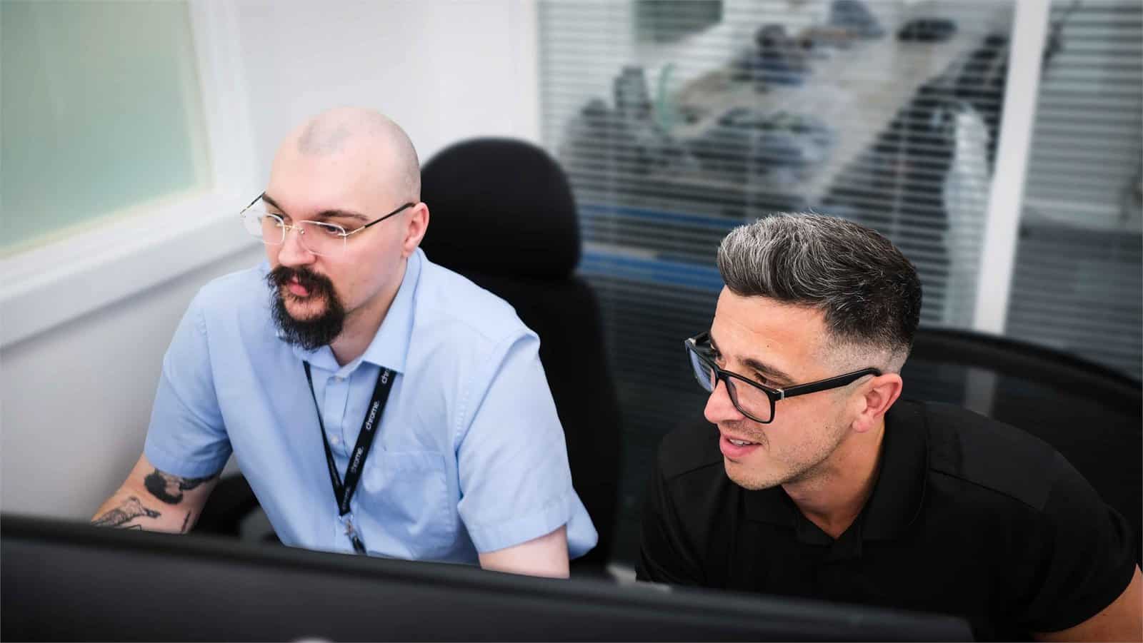 Jake and Matt working together at a desk, supporting IT consultancy