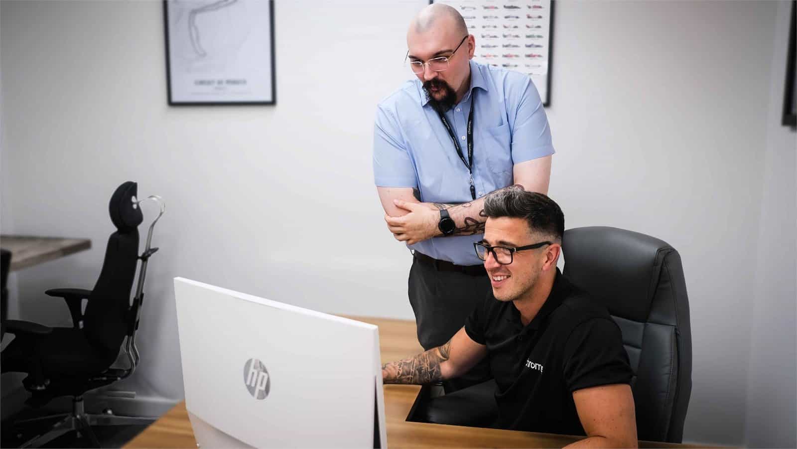 Jake talking with a colleague at his desk, supporting the PSTN switch-off
