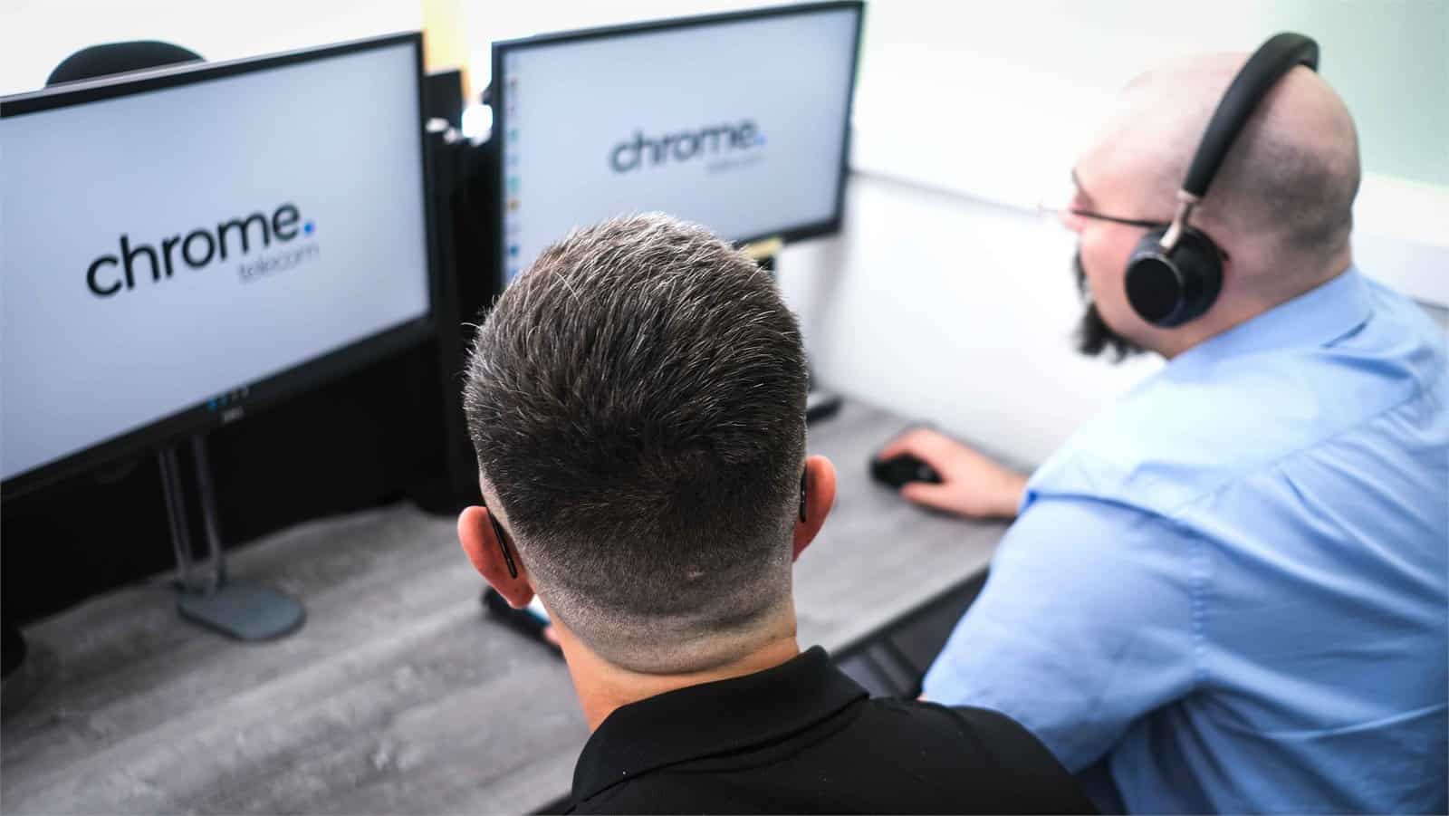 Matt and Jake reviewing work on screen together, supporting business process support
