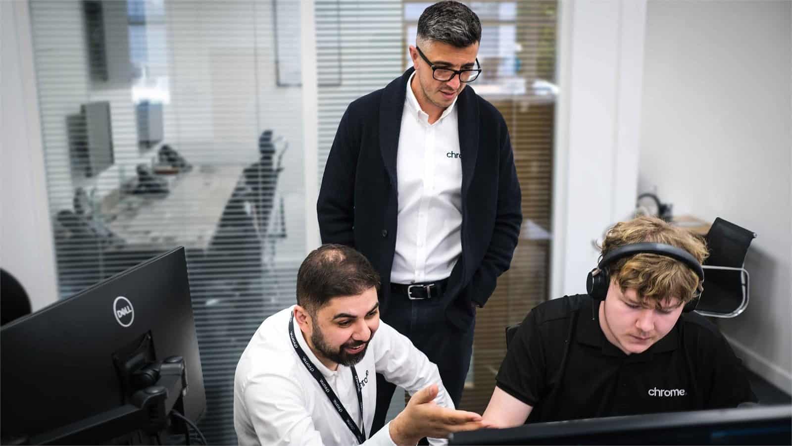 Members of the Chrome Telecom technical team working together in the office, supporting managed IT support