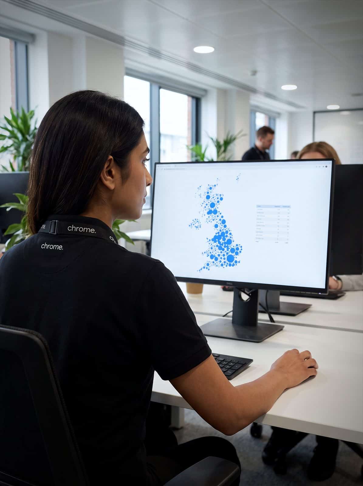 Chrome Telecom team member reviewing the Switch-off Britain full-fibre map on a monitor in the Chrome office