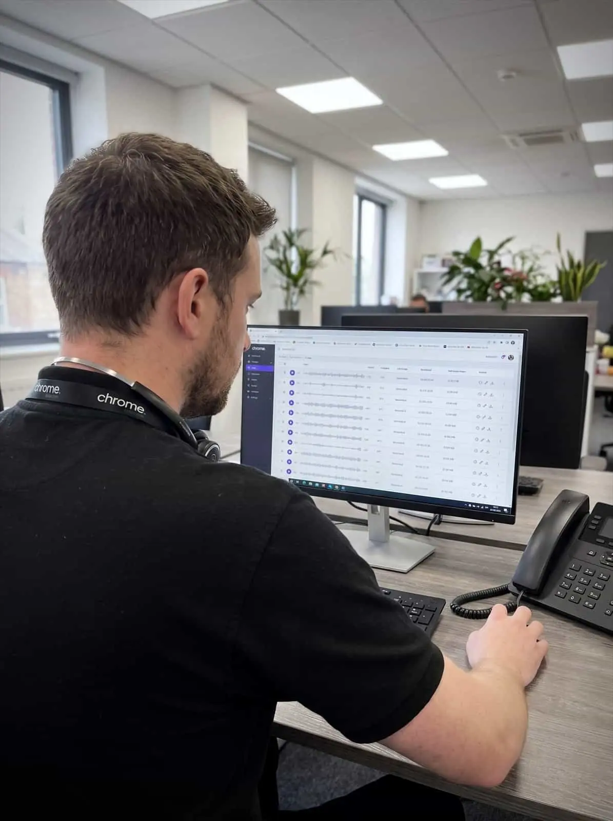 A Chrome Telecom colleague reviews a list of recorded calls on screen, each with playback controls