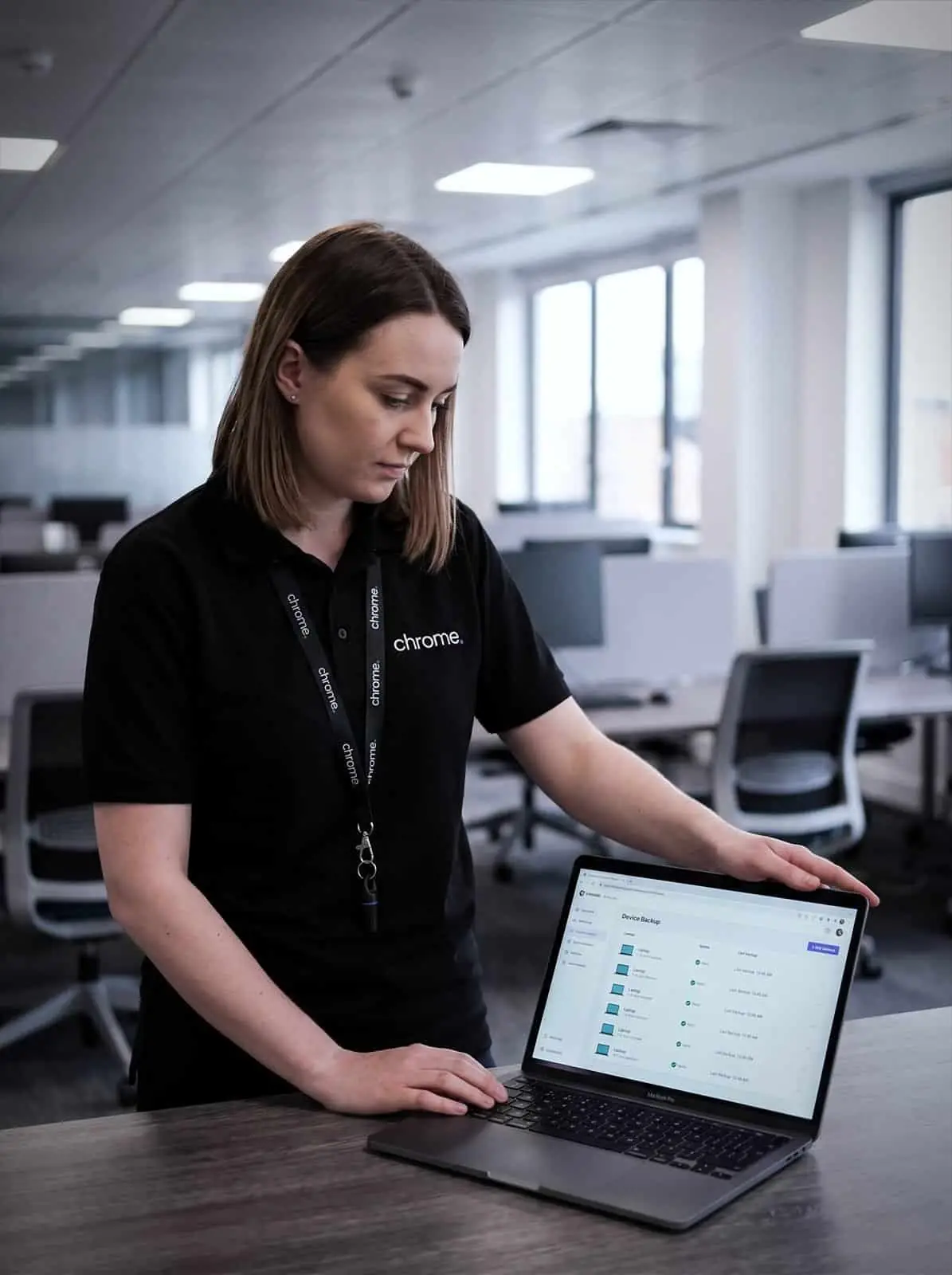 A Chrome Telecom colleague checks device backup status for a fleet of laptops