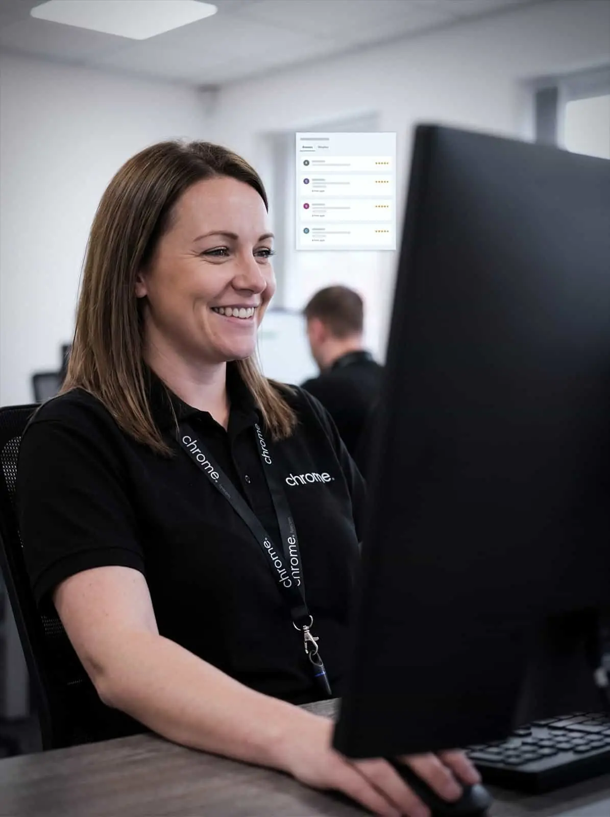 A Chrome Telecom colleague reads customer reviews at her desk